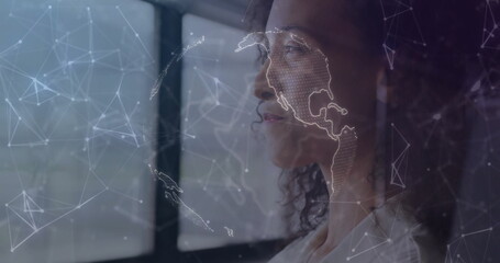 Gazing businesswoman wearing white blouse viewing network map overlay at office window, copy space