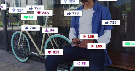 Sitting man checking smartphone on bench outside store, with mint-green bike and social media icons