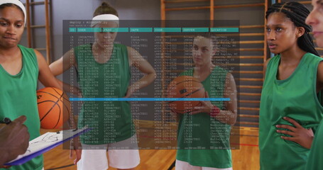 Coach guiding players in green jerseys inside gym, with clipboard, basketball and code overlay