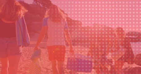 Naklejka premium Walking five friends carrying beach gear along sandy shoreline by cliffs, with blue portable cooler