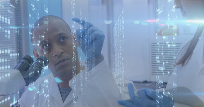 Inspecting male scientist in lab coat holding sample in laboratory with microscope vials holograms