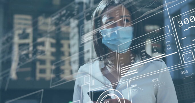 Studying mid adult woman wearing eyeglasses and mask analyzing holographic data panels in tech lab