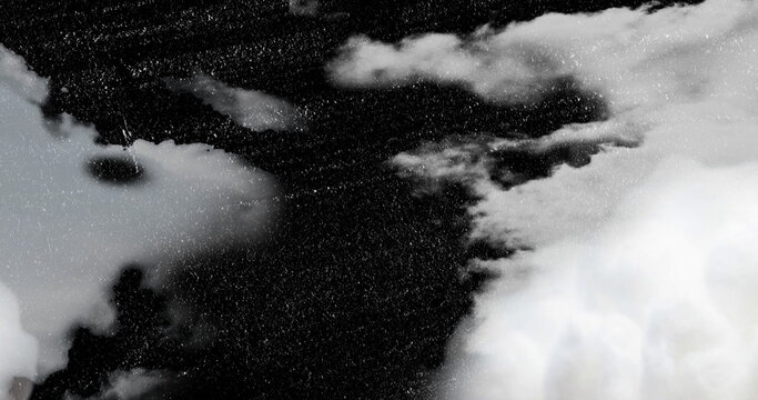Fototapeta Displaying dark cloud mass dividing gray and white clouds overhead, with stormy texture