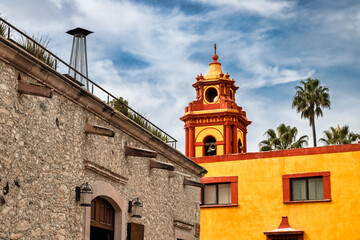 Colorful bell tower and stone building facade in Bernal, Mexico