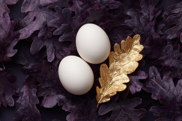 Two white eggs rest on a bed of purple leaves, with a golden leaf in between