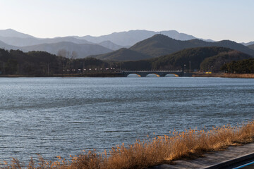 view of the calm lake with the stone bridge
