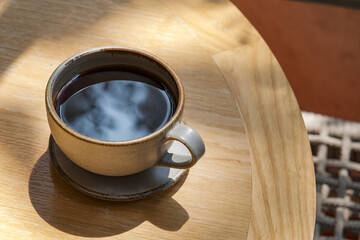 hot black coffee on the wooden table at cafe