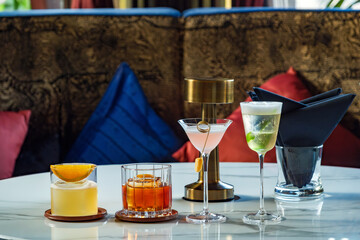 many type of cocktail and glass type on white marble table in the bar