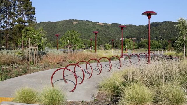 Outdoor spiral bike rack with lamp posts and hills
