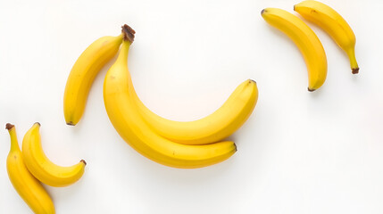 Vibrant yellow bananas creatively arranged on a white backdrop creating a refreshing and appetizing minimalist still life composition