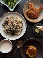 Korean-inspired home meal with rice, wings, seaweed.
