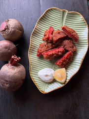 Crispy fried meat bites with beets lemon.