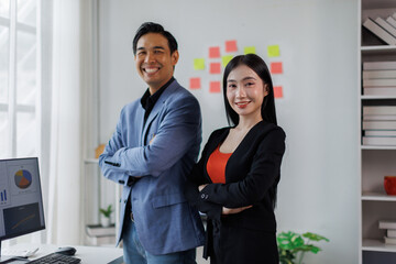 Happy Two Young Asian business couple working together, completing the assigned work
