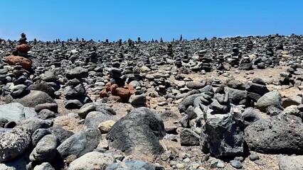 This breathtaking view showcases a stunningly rocky landscape with impressive stone stacks beneath bright blue skies