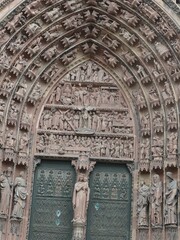 Ornate main portal of Strasbourg Cathedral revealing intricate biblical sculptures and carved...