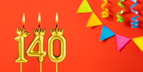 Number 140 birthday candle on an orange background with pennants
