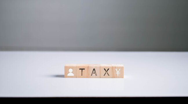 Wooden blocks showing TAX and Japan yen symbol on white table represent income tax in Thailand, financial planning, accounting, and taxation system with minimalist concept clean background.