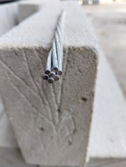 Close up photo of 7 spiral aluminum cables on top of hebel 