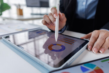 Business asian woman working at office with tablet and document, doing planning analyzing the...