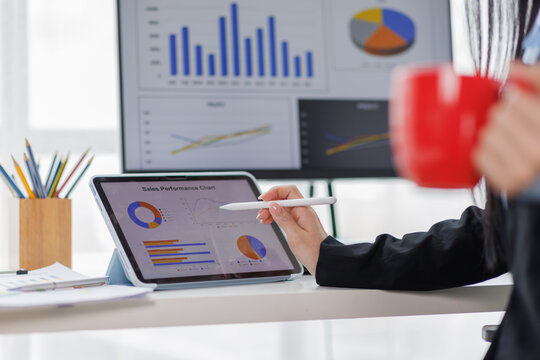 Tax payments, accounting for business, financial literacy, A business asian woman keeps records using a calculator and a laptop
