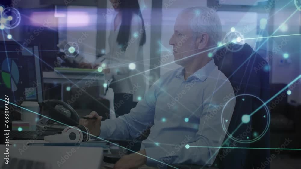 Poster man typing on keyboard triggers digital overlay while coworker reviews tablet for business planning