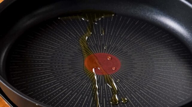  Close-Up of Pouring Oil into Frying Pan &ndash; Cooking Preparation.