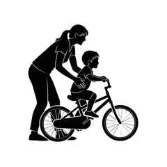 Obraz premium Silhouette of a mother helping her young son learn to ride a bicycle.