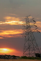 Vertical High voltage pole electric wiring distribution landscape energy engineering. Electricity energetic sunset green mountain in countryside. Vertical Electric power energy engineering industrial