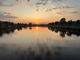River Ness at sunset with setting sun reflected in the river water in Inverness Scotland