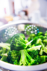 Vibrant Steamed Broccoli in Stainless Steel Strainer &ndash; Fresh Vegan Cooking Concept