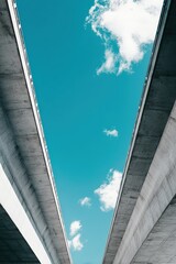 Abstract perspective of modern architecture showcasing blue sky framed by concrete structure, innovative urban infrastructure design highlighting symmetry and minimalism