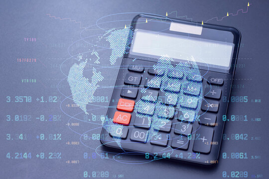 Calculator with a digital world map and stock data overlay. Technology concept global finance, trading analytics, and digital economy trends.