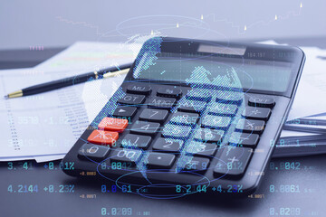 Calculator with holographic world map and financial data overlay on office desk. Global business...