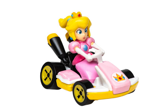 Supermario Bros character Princess Peach figurine driving a race kart on white background