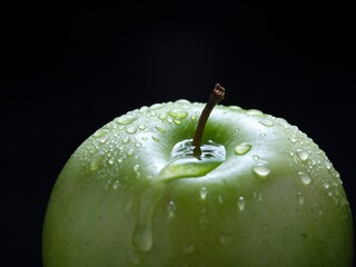  Water covering a green apple.
