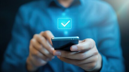 A male user is engaging with his smartphone, displaying a digital checkmark icon on the screen, symbolizing task completion or successful communication in a modern setting.