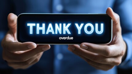 A close-up of a person holding a smartphone displaying a glowing 'THANK YOU' message in blue, conveying appreciation. The individual's hands are visible, with a focus on the phone's screen.