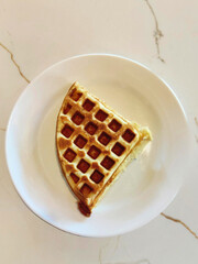 Golden Crispy Quarter Waffle on White Plate