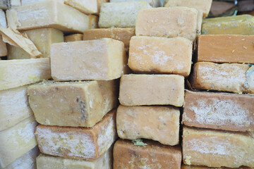 Natural handmade soap bricks stacked for sale in market