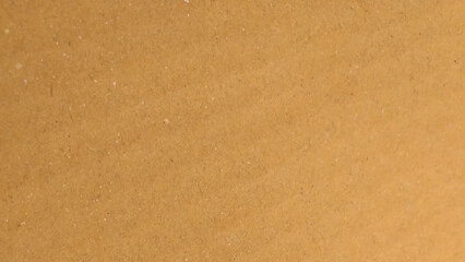 Brown color paper shown grain details on  it surface. carton paper or seamless carton background. Yellow paperboard texture.
