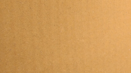 Brown color paper shown grain details on  it surface. carton paper or seamless carton background. Yellow paperboard texture.
