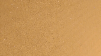 Brown color paper shown grain details on  it surface. High resolution seamless yellow cardboard background.