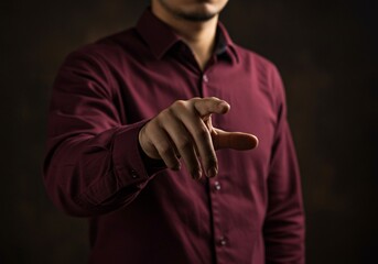 Man pretending to touch an invisible screen against black