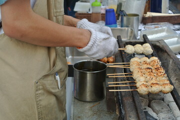 chef preparing yakitori on the grill