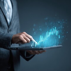 Businessman interacting with a tablet displaying upward trending data
