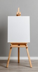 Blank canvas on a wooden easel against a gray wall