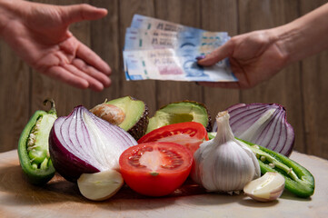 Closing negotiations and sales of fresh vegetables, and below against a blurred Person's hand...