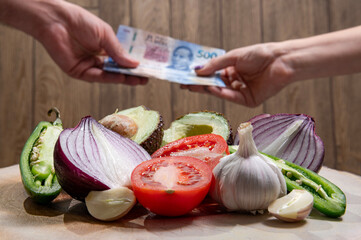 Closing negotiations and sales of fresh vegetables, and below against a blurred Person's hand...