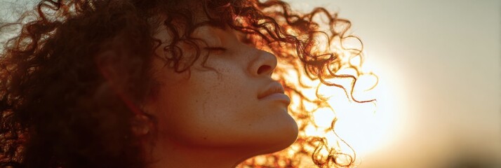 Natural Curls Glow in Golden Hour Light Highlighting Serene Beauty and Peaceful Expression in a Side-View Composition