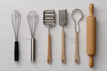 A collection of essential kitchen tools arranged neatly on a countertop for baking preparation